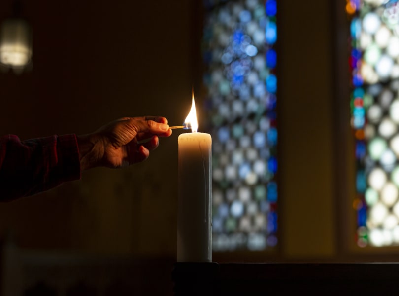 someone lighting a candle
