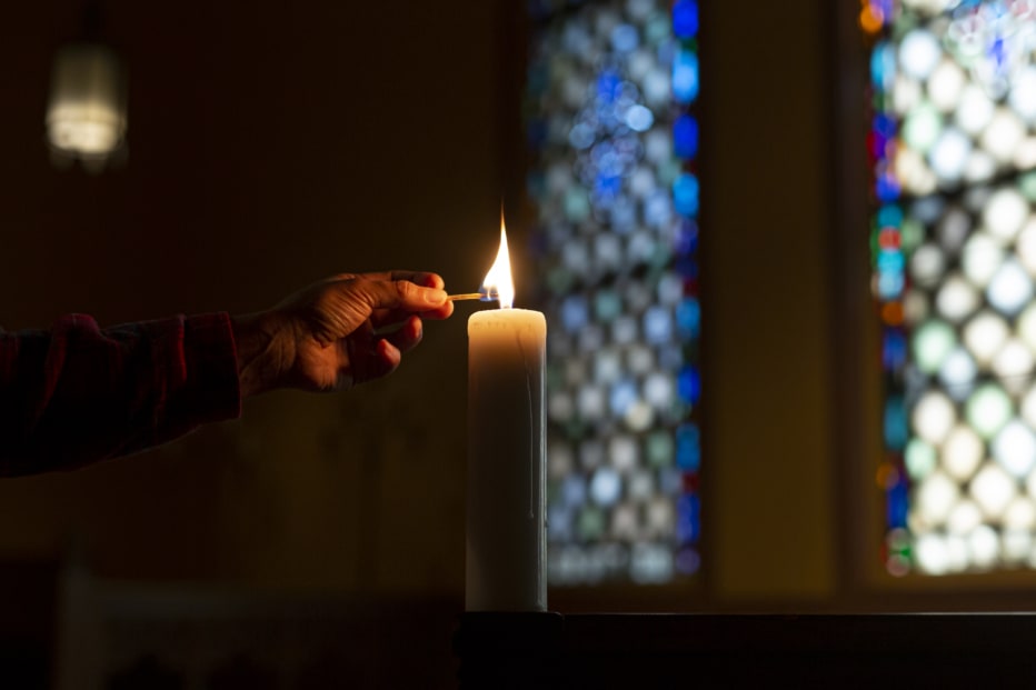 someone lighting a candle