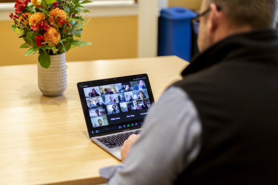 A laptop running a Zoom meeting for church members