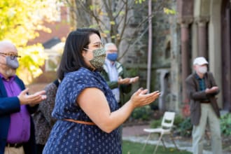 A woman extends her hands in prayer