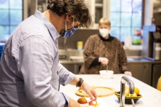 A man preps a meal for people experiencing food insecurity