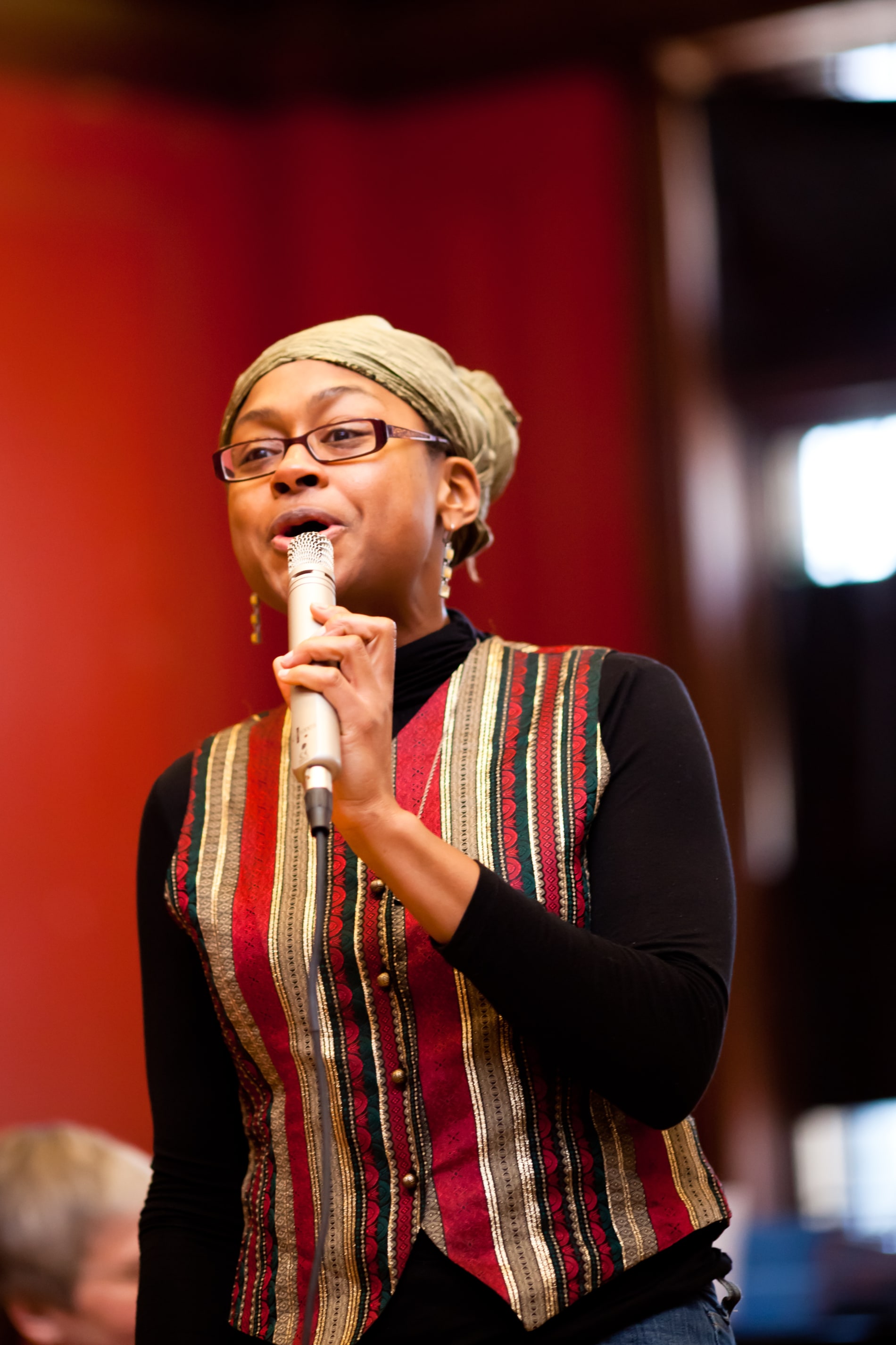 A Black woman speaks into a microphone