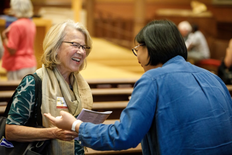 two people greeting each other in worship