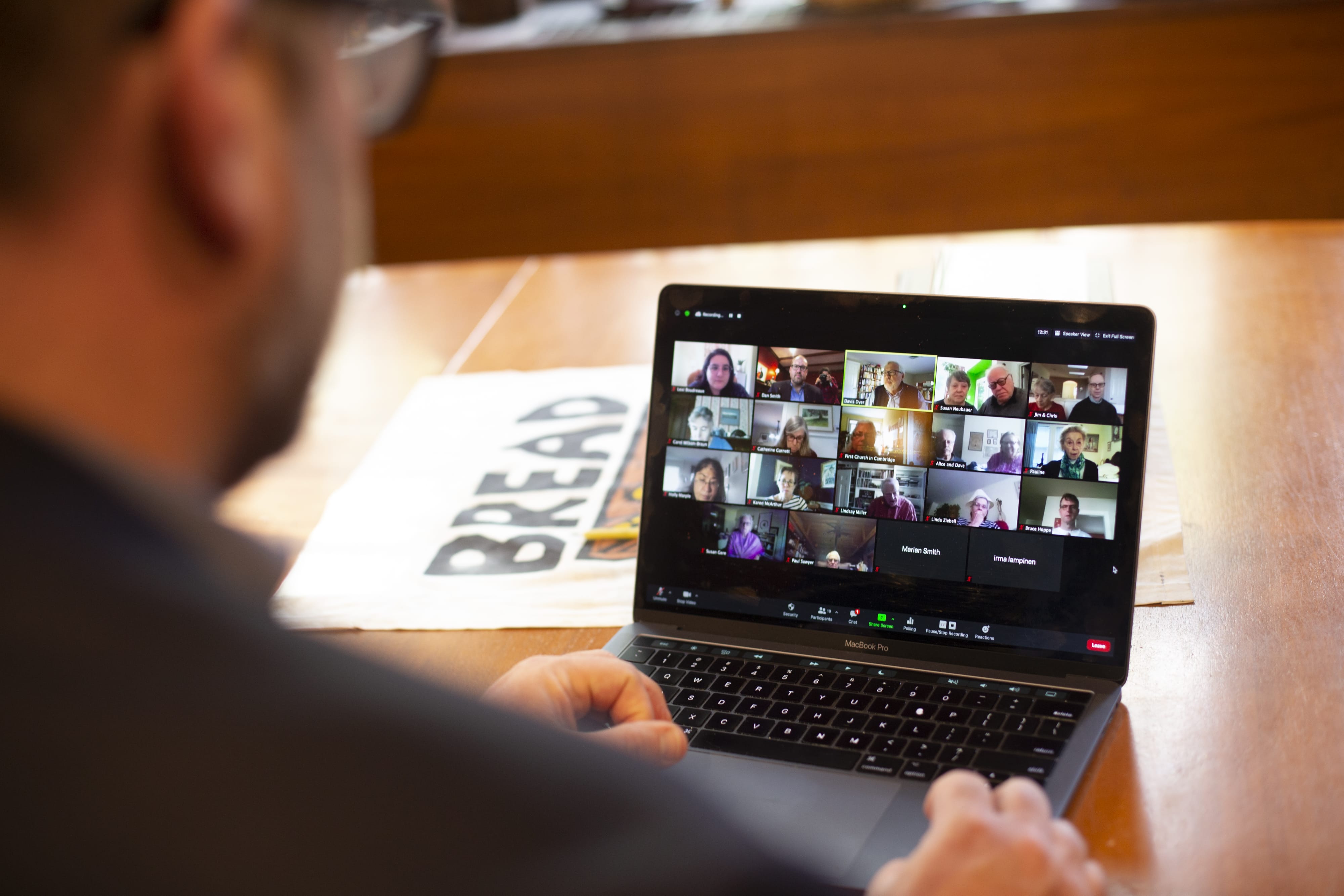 Dan leading a zoom call, People Staff, faith formation A man leading a zoom call in an office