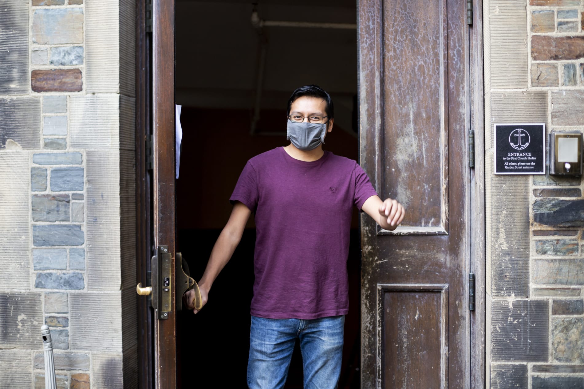 man walking out of shelter door