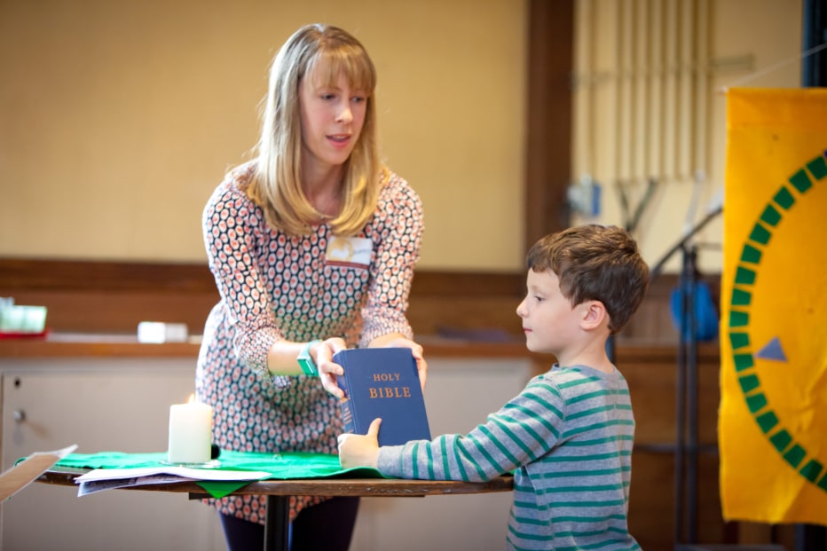 Church School teacher and student begin their class with worship.