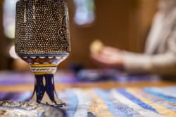 cup with bread broken in the background