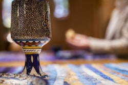 cup with bread broken in the background