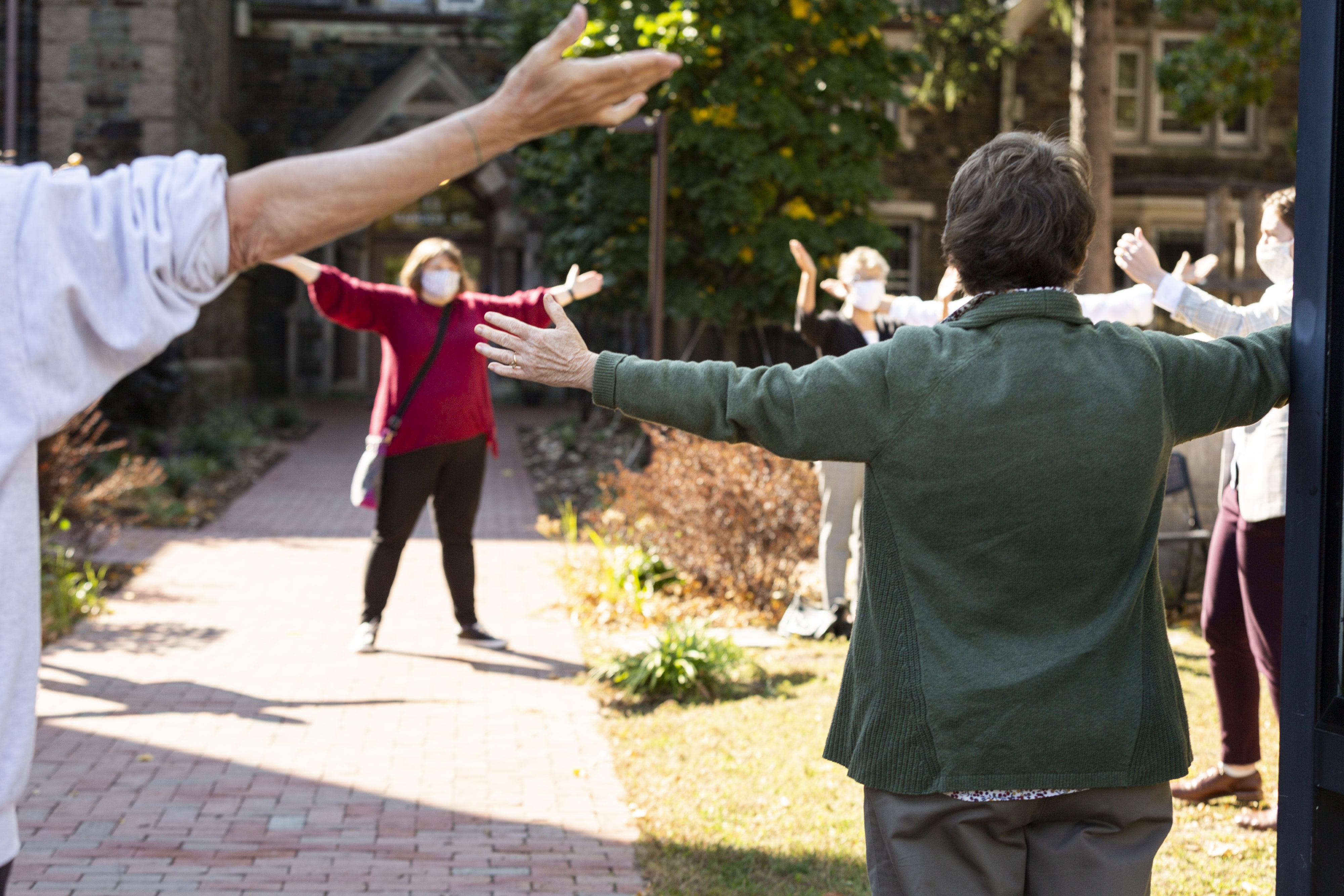 people, members, circle of outstretched arms church lawn
